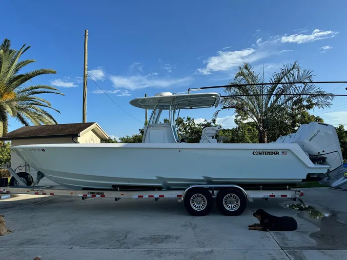  Yacht Photos Pics 2024 Contender 32 ST boat on trailer, parked outdoors with palm trees in the background.