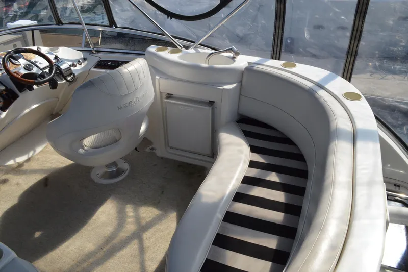 Alta Levica Yacht Photos Pics 2006 Meridian 368 Motoryacht interior with helm, seating, and striped carpet.