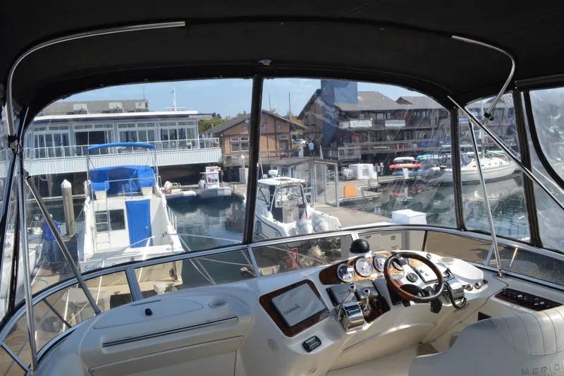 Alta Levica Yacht Photos Pics 2006 Meridian 368 Motoryacht helm view at marina, showcasing dashboard and waterfront.