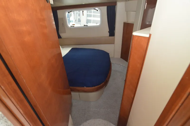 Alta Levica Yacht Photos Pics 2006 Meridian 368 Motoryacht cabin interior with bed, wooden accents, and window view.