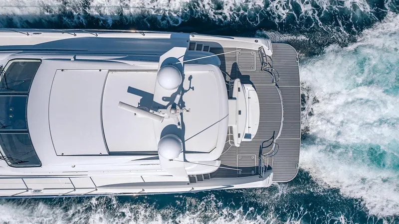  Yacht Photos Pics Aerial view of a 2010 Custom 650 Catamaran cruising through ocean waves.