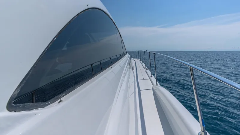  Yacht Photos Pics Custom 650 Catamaran 2010 cruising on open sea, side view of deck and railing.