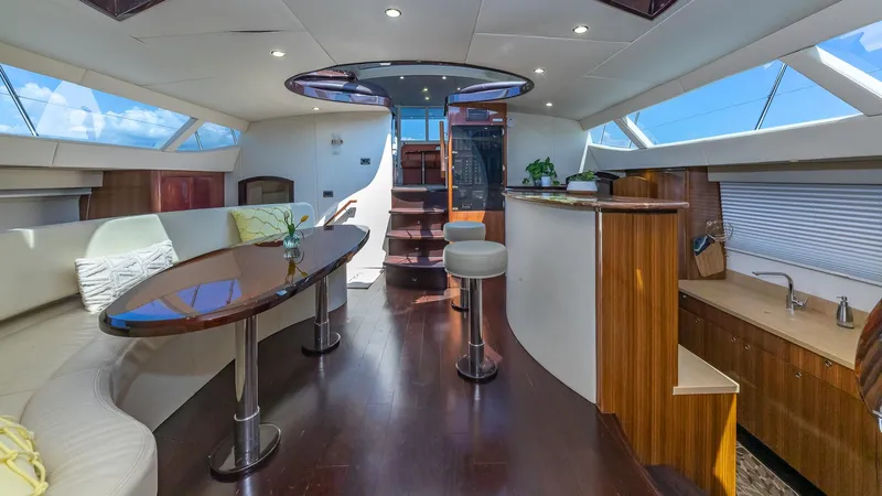  Yacht Photos Pics Luxurious interior of 2010 Custom 650 Catamaran with modern seating and wooden finishes.
