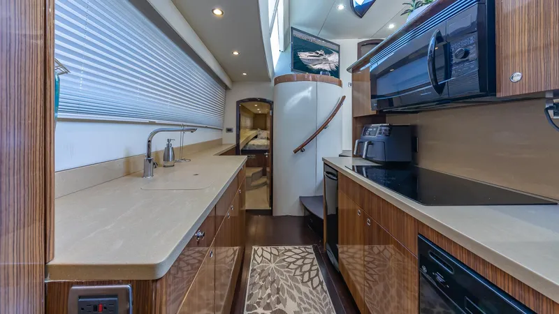  Yacht Photos Pics Luxurious kitchen interior of a 2010 Custom 650 Catamaran with modern appliances and sleek design.