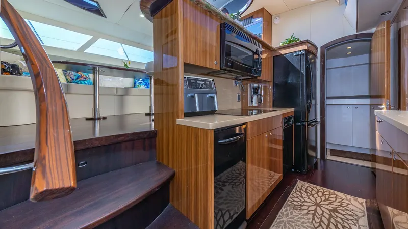  Yacht Photos Pics Luxurious 2010 Custom 650 Catamaran kitchen with modern appliances and wood finishes.