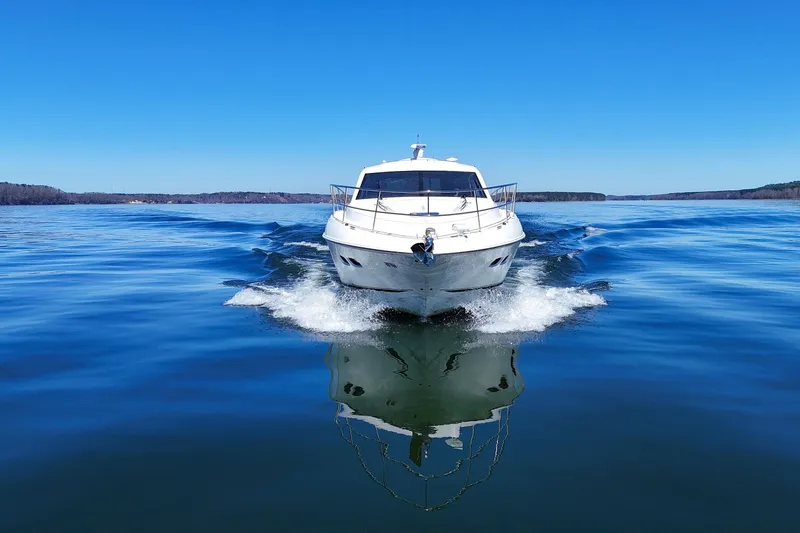  Yacht Photos Pics 2016 Sea Ray Sundancer 510 cruising on a clear blue lake under a bright sky.