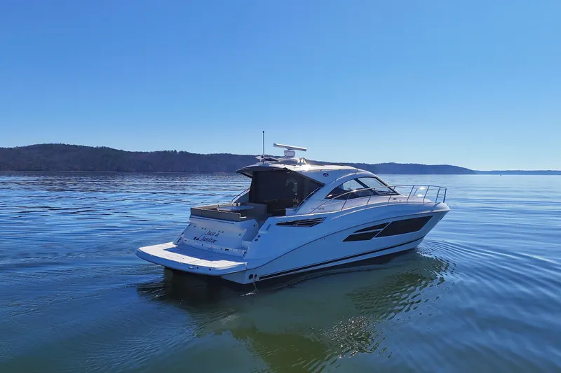  Yacht Photos Pics 2016 Sea Ray Sundancer 510 yacht cruising on calm waters under clear blue sky.