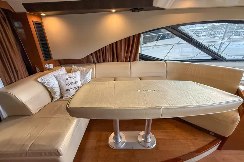  Yacht Photos Pics Luxurious interior of 2016 Sea Ray Sundancer 510 yacht with beige seating and table.