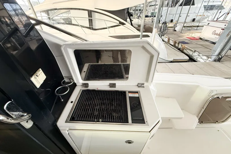  Yacht Photos Pics Outdoor grill on 2016 Sea Ray Sundancer 510 yacht deck, docked at marina.