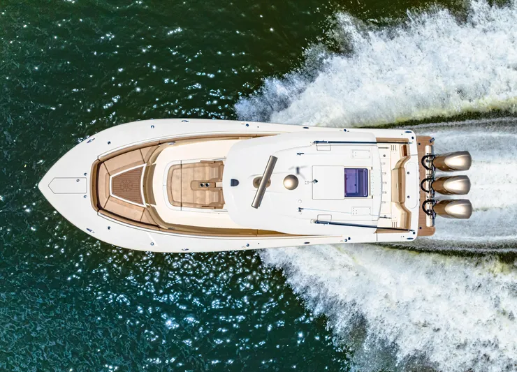  Yacht Photos Pics Aerial view of a 2018 Scout 380 LXF boat cruising on water.