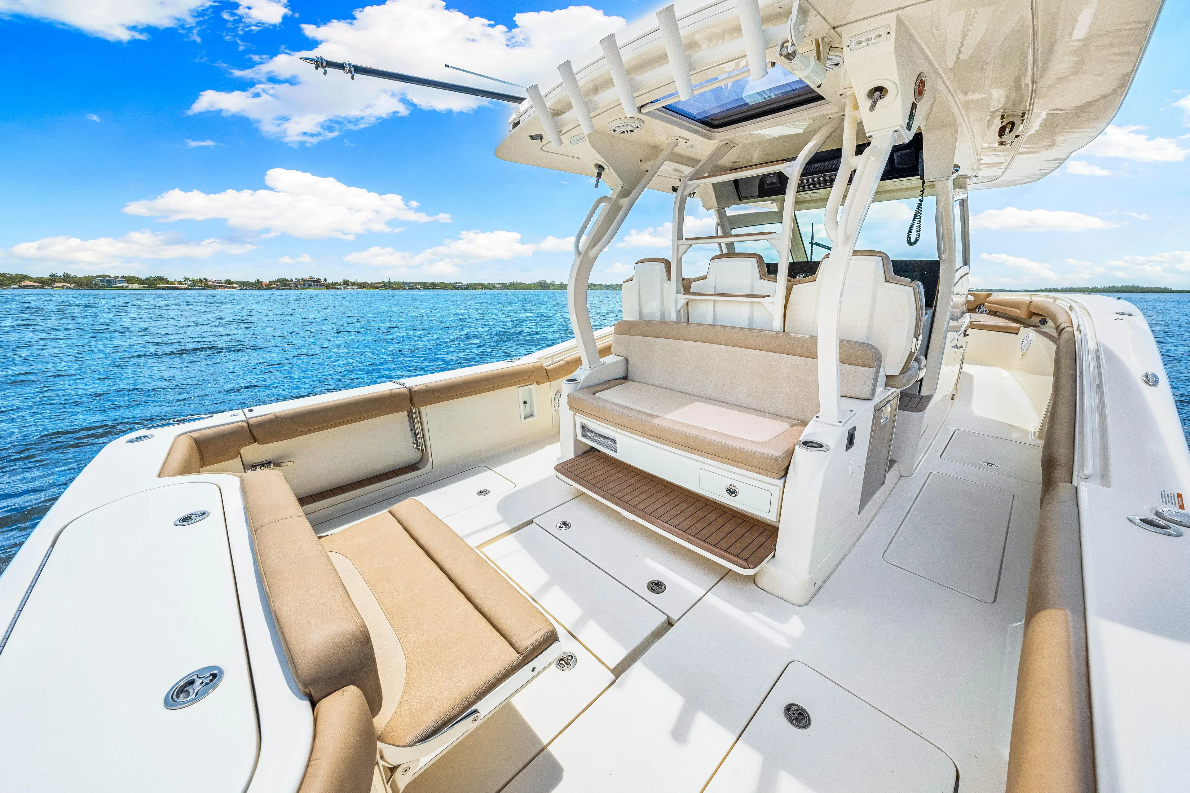 Yacht Photos Pics 2018 Scout 380 LXF boat interior with seating, on a sunny day.