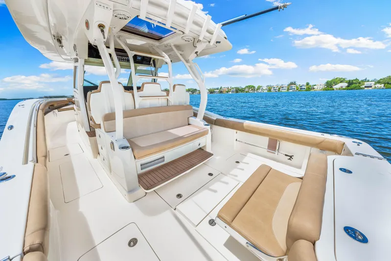  Yacht Photos Pics 2018 Scout 380 LXF boat interior with seating, on a sunny day by the water.