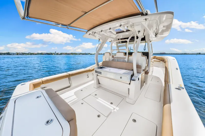  Yacht Photos Pics 2018 Scout 380 LXF boat interior with seating and open deck on a sunny day.