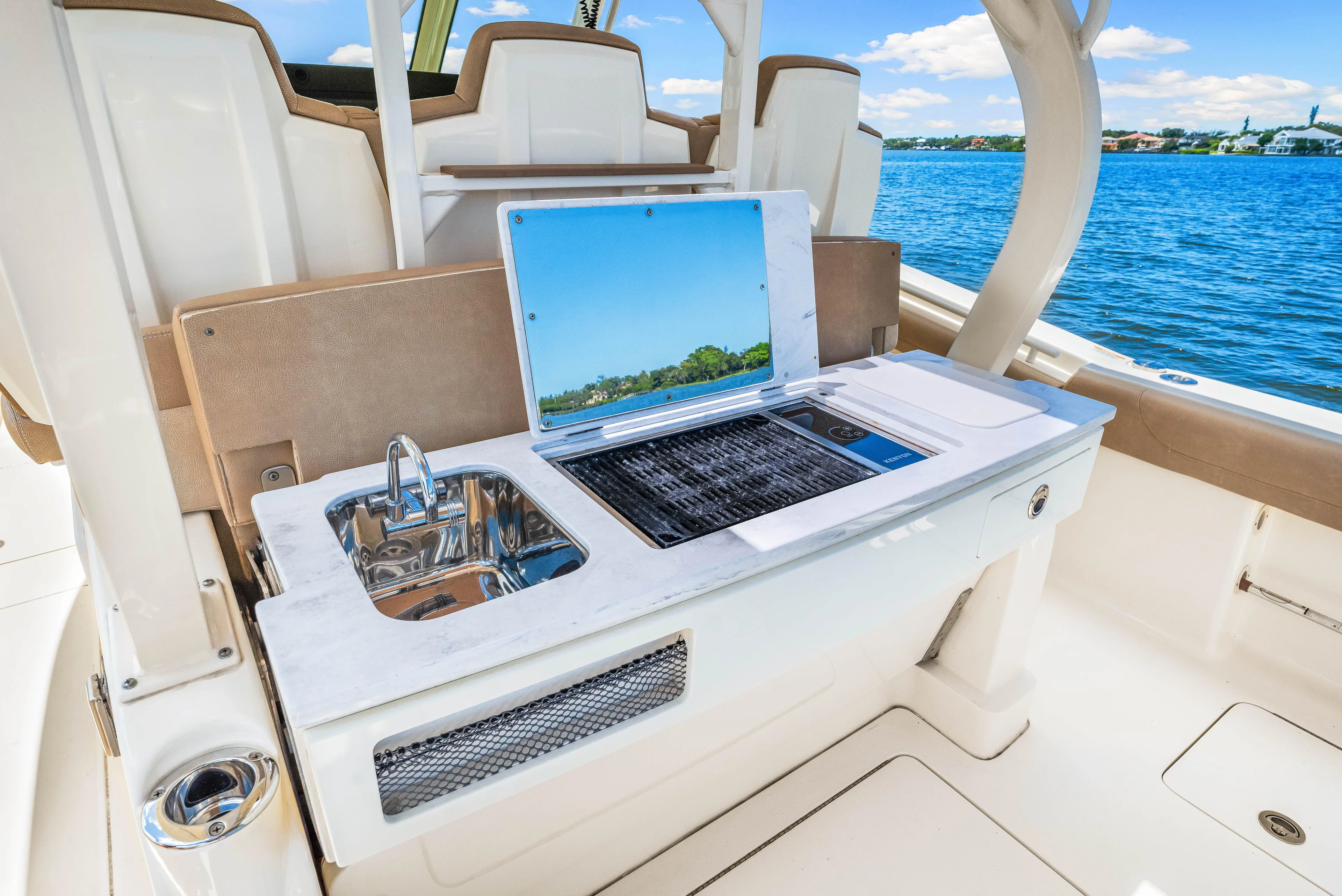  Yacht Photos Pics 2018 Scout 380 LXF boat with outdoor kitchen and sink by the water.