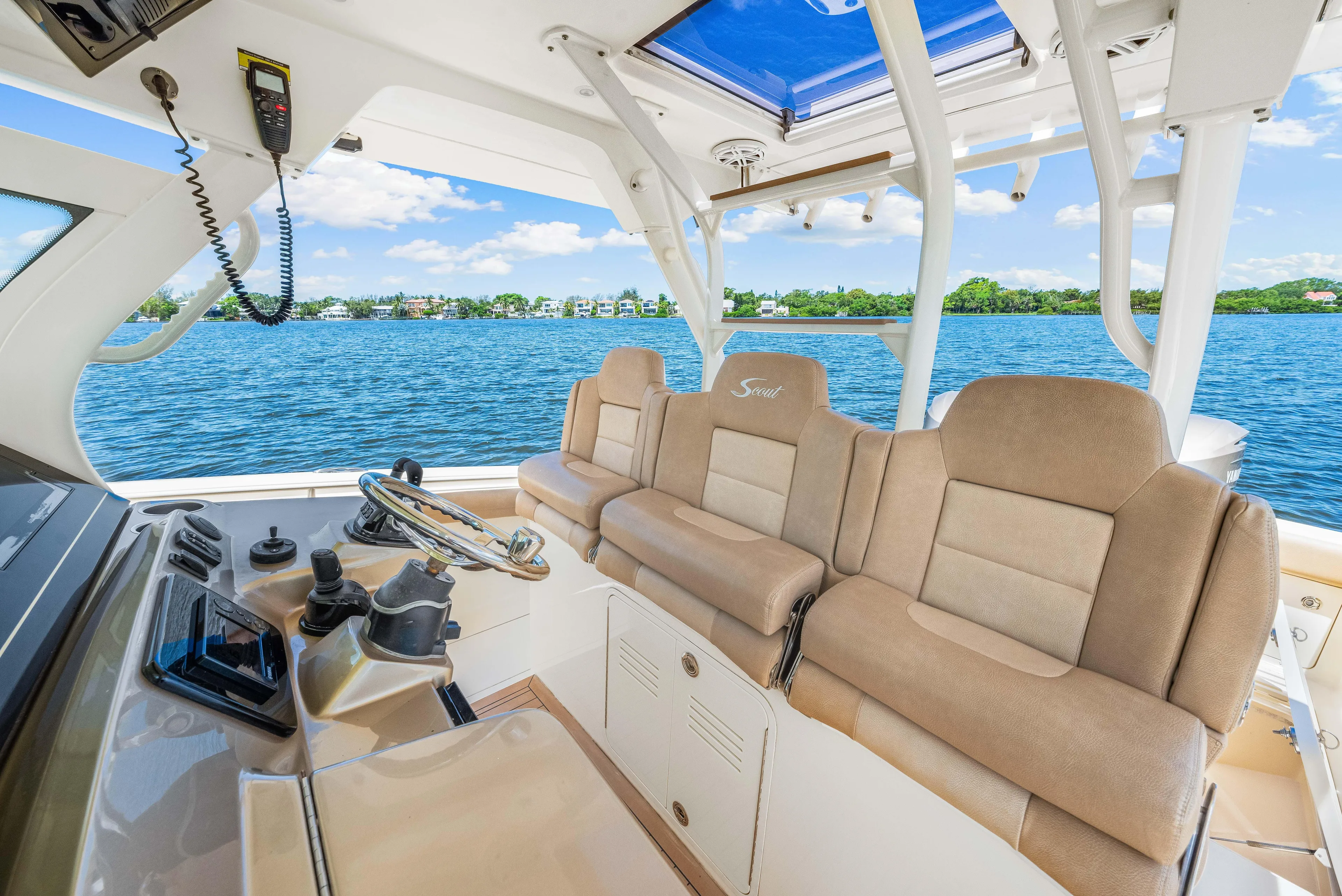  Yacht Photos Pics 2018 Scout 380 LXF boat interior with beige seating and ocean view.