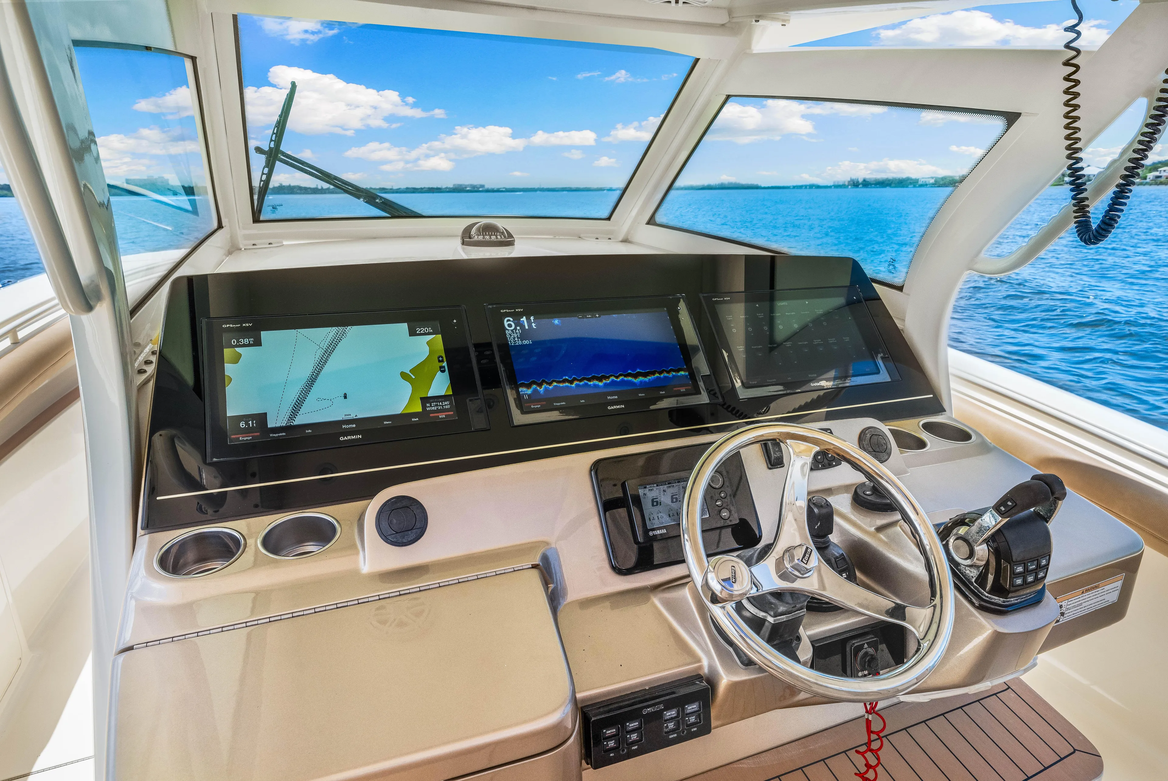  Yacht Photos Pics 2018 Scout 380 LXF boat dashboard with navigation screens and steering wheel.