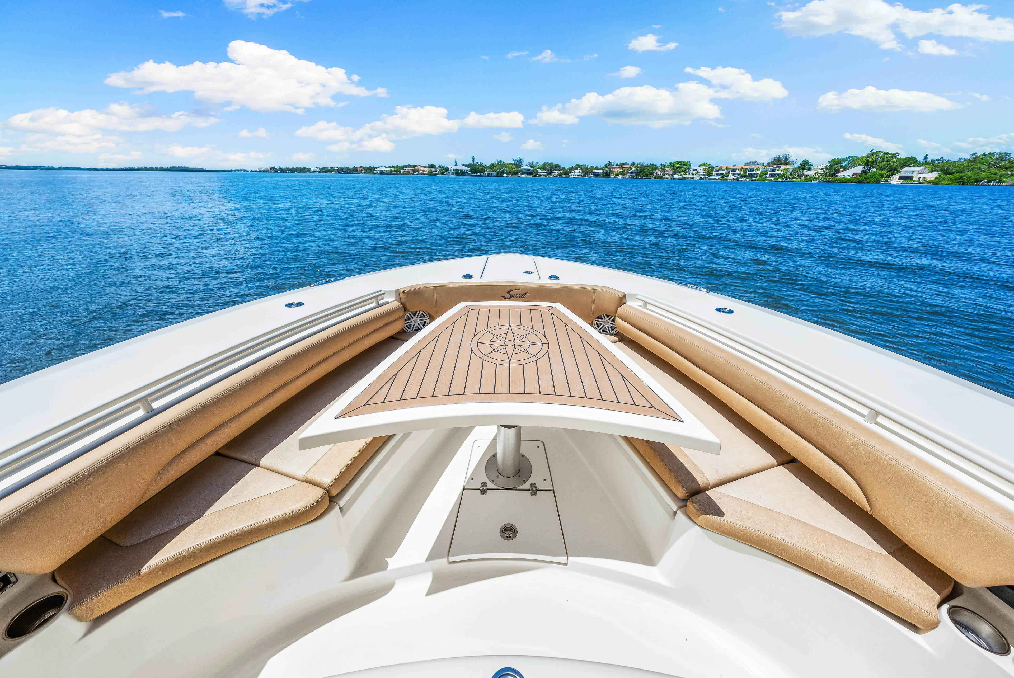  Yacht Photos Pics 2018 Scout 380 LXF boat bow with tan seating and wooden deck on a sunny day.