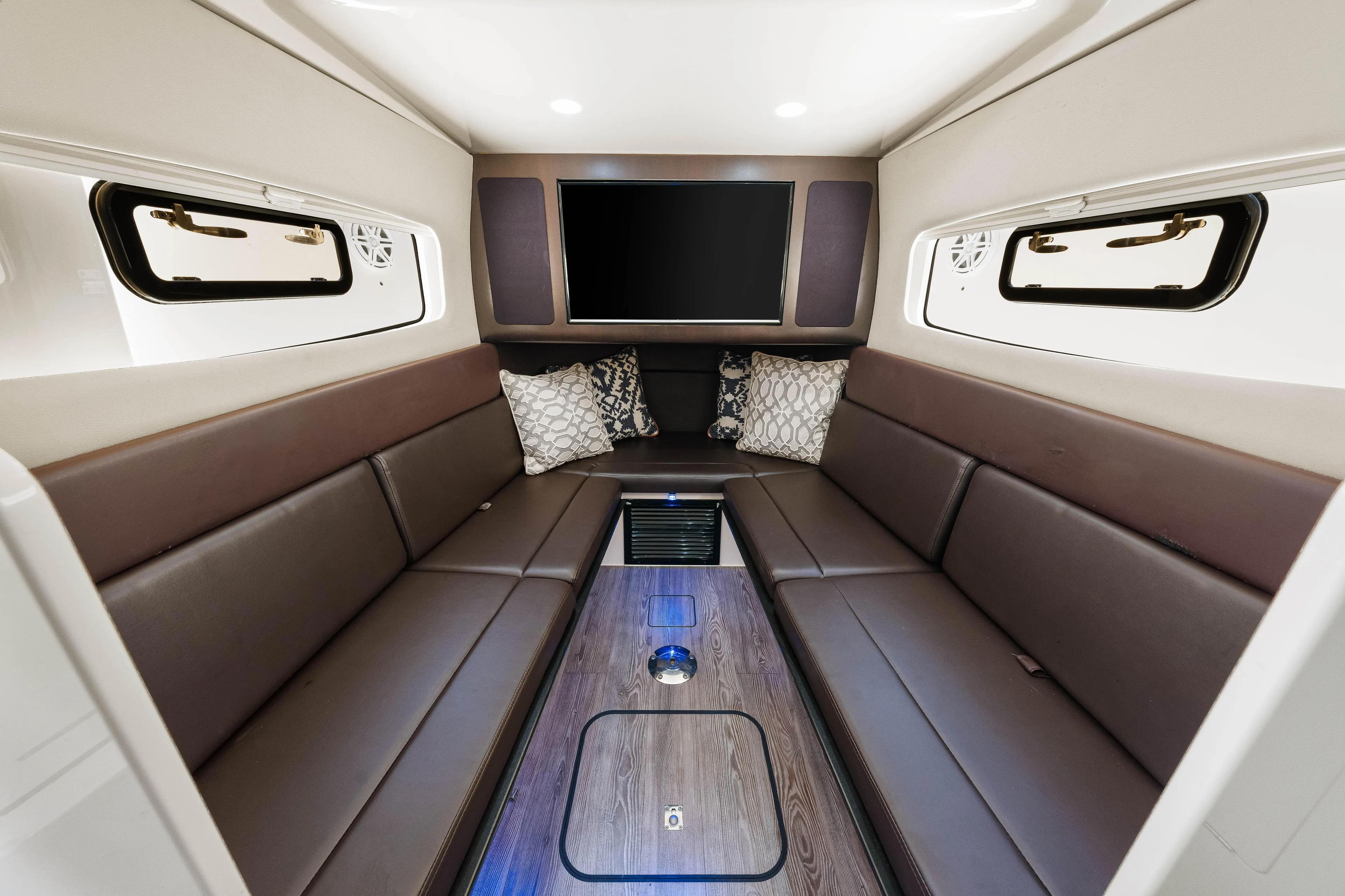  Yacht Photos Pics Luxurious interior of 2018 Scout 380 LXF boat with leather seating and TV.