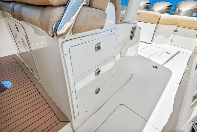  Yacht Photos Pics 2018 Scout 380 LXF boat interior with storage compartments and cushioned seating.