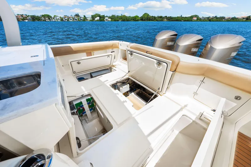  Yacht Photos Pics 2018 Scout 380 LXF boat interior with open storage compartments and Yamaha outboard motors.