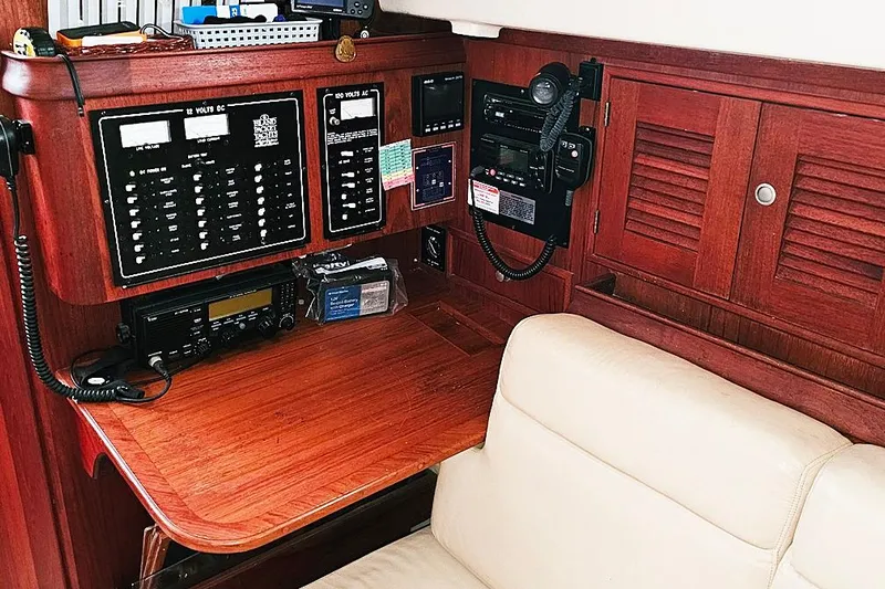  Yacht Photos Pics Navigation station of 2000 Island Packet 350 sailboat with control panels and communication equipment.