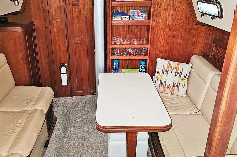  Yacht Photos Pics Interior of 2000 Island Packet 350 sailboat with cozy seating and wooden cabinetry.