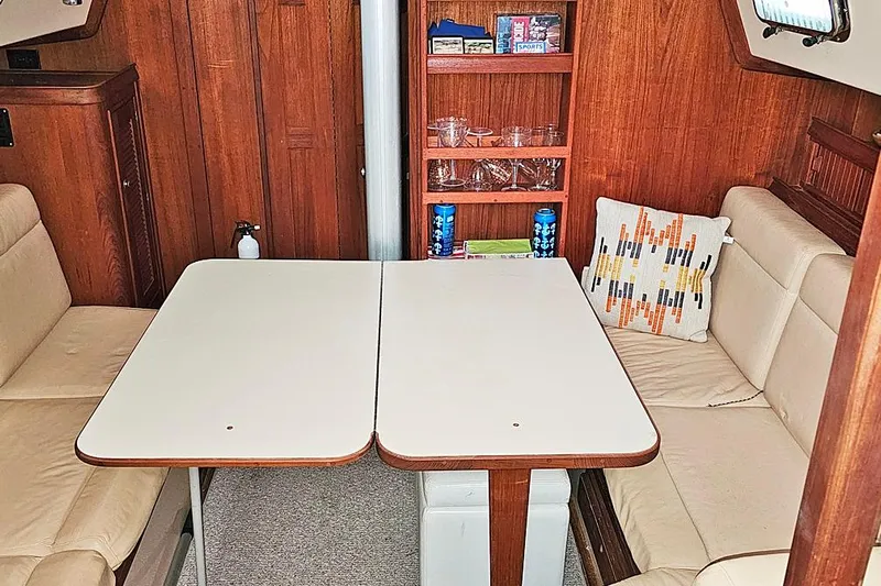  Yacht Photos Pics Interior of 2000 Island Packet 350 sailboat with cozy seating and dining table.