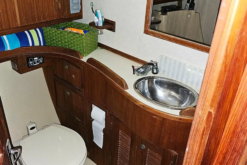  Yacht Photos Pics Bathroom interior of 2000 Island Packet 350 yacht with wooden cabinetry and stainless steel sink.