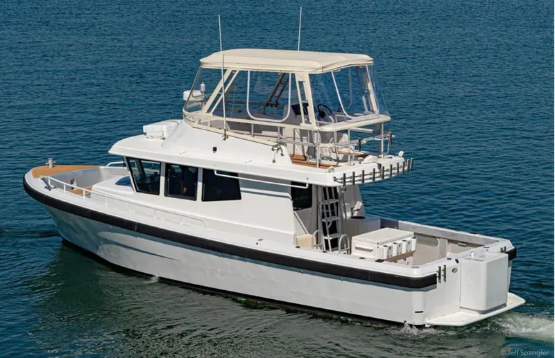  Yacht Photos Pics Custom 2011 Imax Fishing Boat on calm blue water, featuring a spacious deck and upper helm.