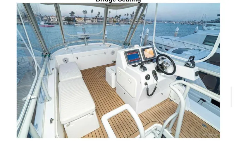  Yacht Photos Pics Custom Imax Fishing Boat 2011 with bridge seating and navigation equipment on a wooden deck.