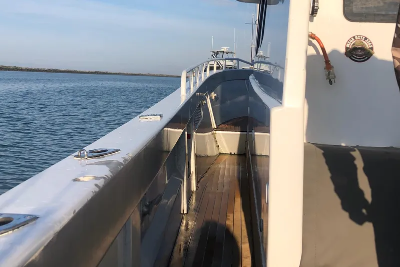  Yacht Photos Pics Custom Imax Fishing Boat 2011 on calm water, showcasing deck and railing.