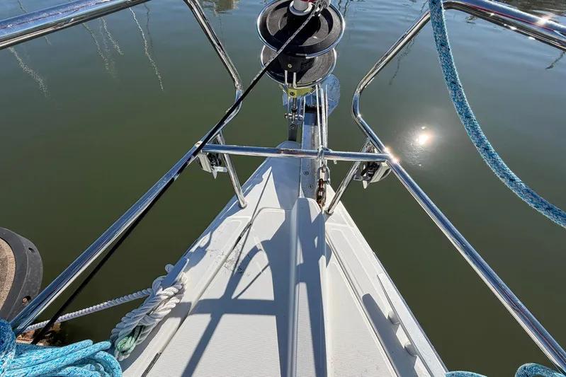 Sea Ranch II Yacht Photos Pics Bow of 2018 Jeanneau Sun Odyssey 389 sailboat with ropes and calm water reflection.