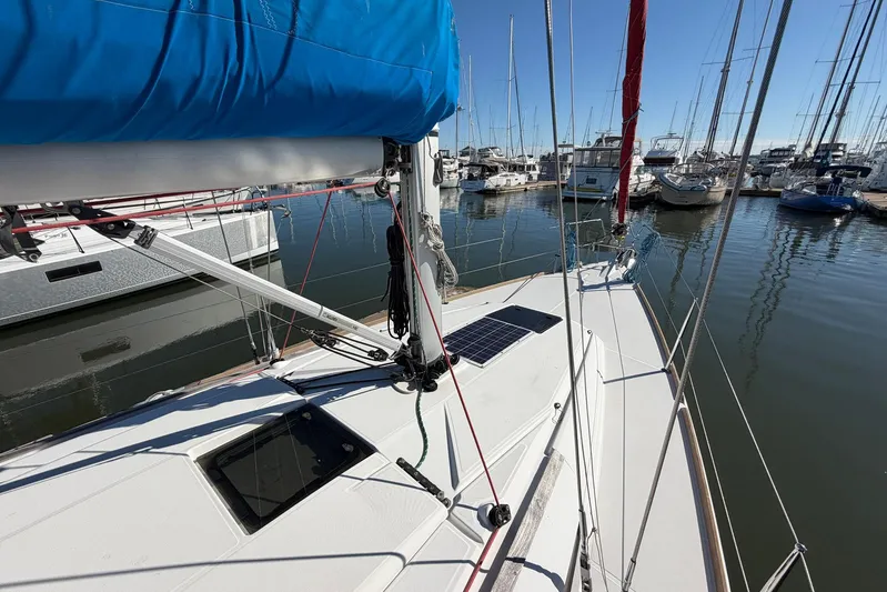 Sea Ranch II Yacht Photos Pics 2018 Jeanneau Sun Odyssey 389 sailboat docked in a marina, featuring a blue sail cover.
