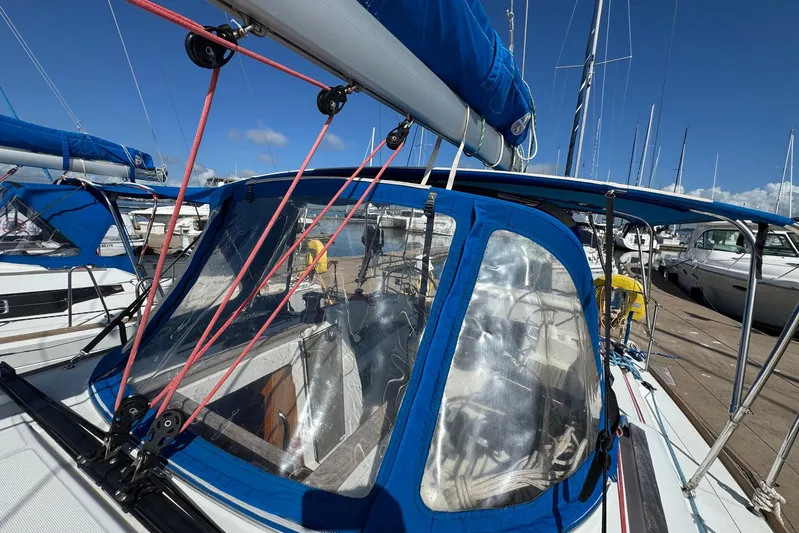 Sea Ranch II Yacht Photos Pics 2018 Jeanneau Sun Odyssey 389 sailboat docked, featuring blue canopy and rigging.