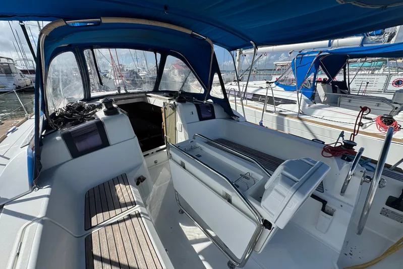 Sea Ranch II Yacht Photos Pics 2018 Jeanneau Sun Odyssey 389 sailboat cockpit with blue canopy and marina view.