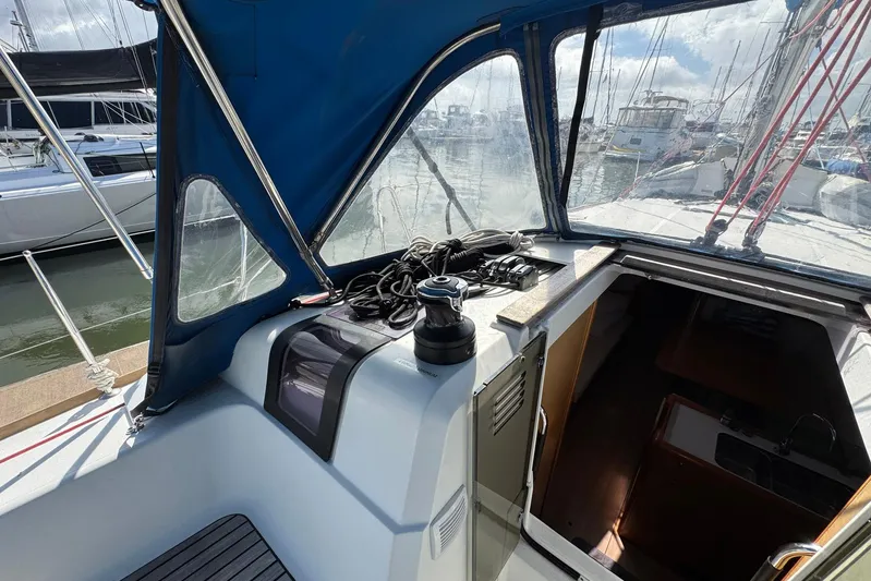 Sea Ranch II Yacht Photos Pics 2018 Jeanneau Sun Odyssey 389 cockpit with blue canopy, docked at marina.