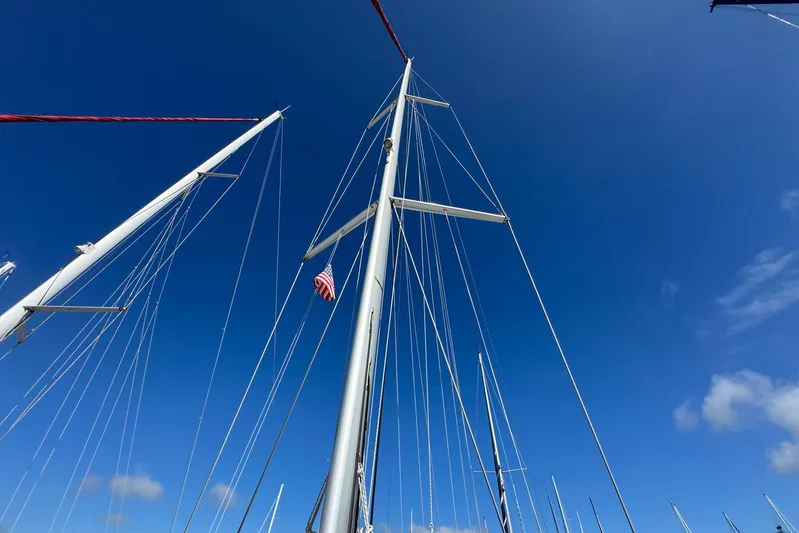 Sea Ranch II Yacht Photos Pics Masts of a 2018 Jeanneau Sun Odyssey 389 sailboat against a clear blue sky.
