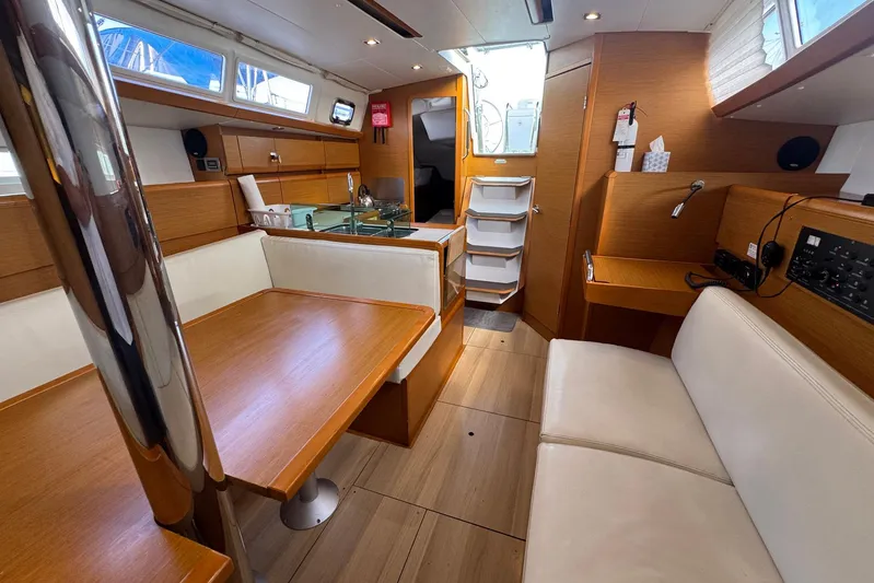 Sea Ranch II Yacht Photos Pics Interior of 2018 Jeanneau Sun Odyssey 389 yacht with wood finish and seating area.