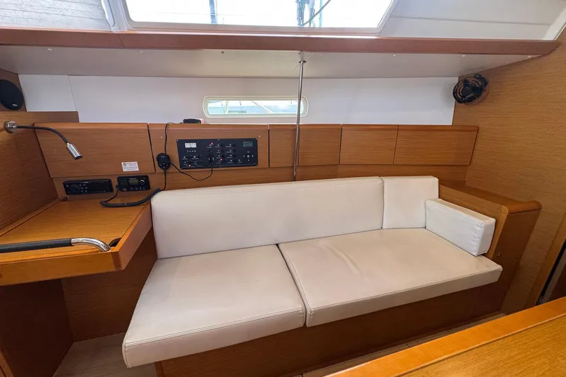 Sea Ranch II Yacht Photos Pics Interior of 2018 Jeanneau Sun Odyssey 389 yacht with white seating and control panel.