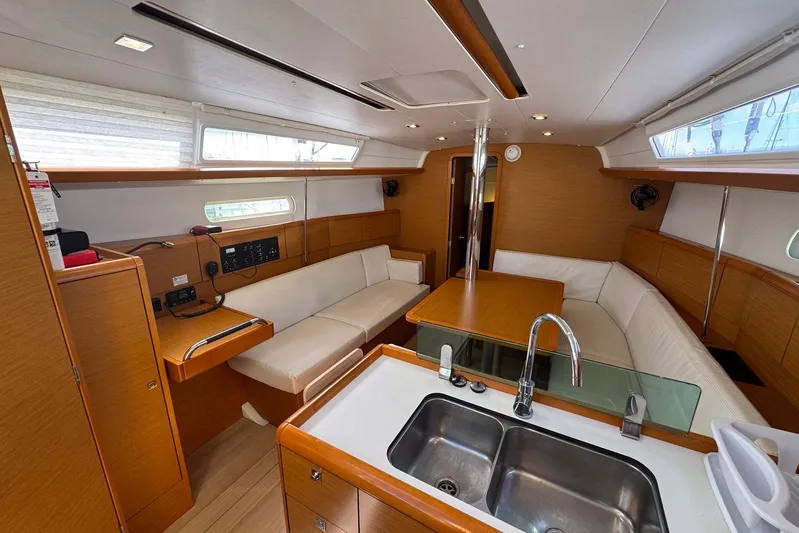 Sea Ranch II Yacht Photos Pics Interior of 2018 Jeanneau Sun Odyssey 389 yacht with modern kitchen and seating area.