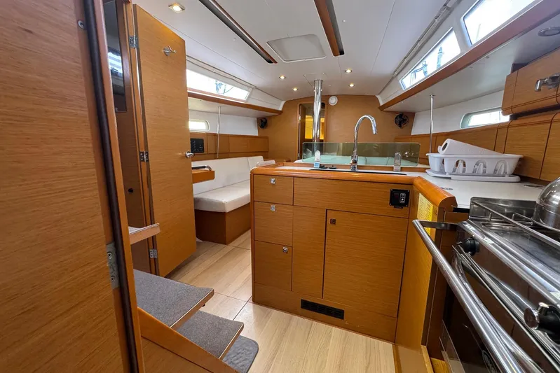 Sea Ranch II Yacht Photos Pics Interior of 2018 Jeanneau Sun Odyssey 389 sailboat with modern kitchen and seating area.