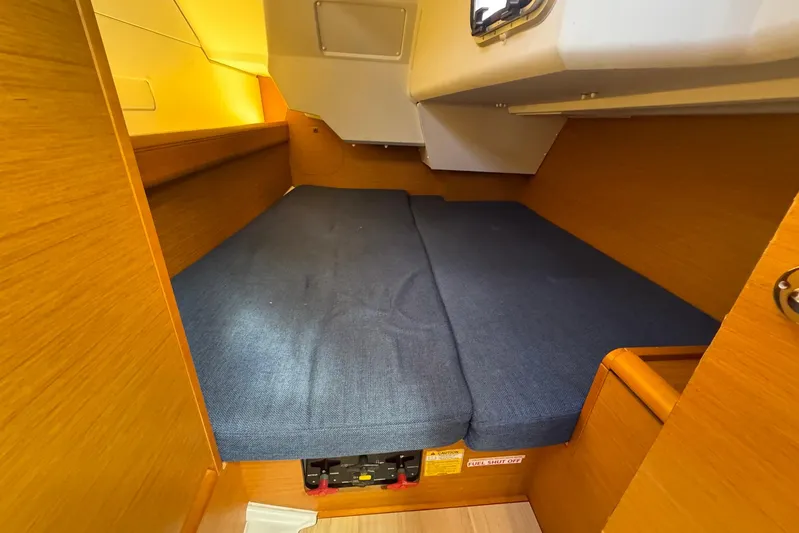 Sea Ranch II Yacht Photos Pics Cozy cabin interior of 2018 Jeanneau Sun Odyssey 389 sailboat with blue cushions.