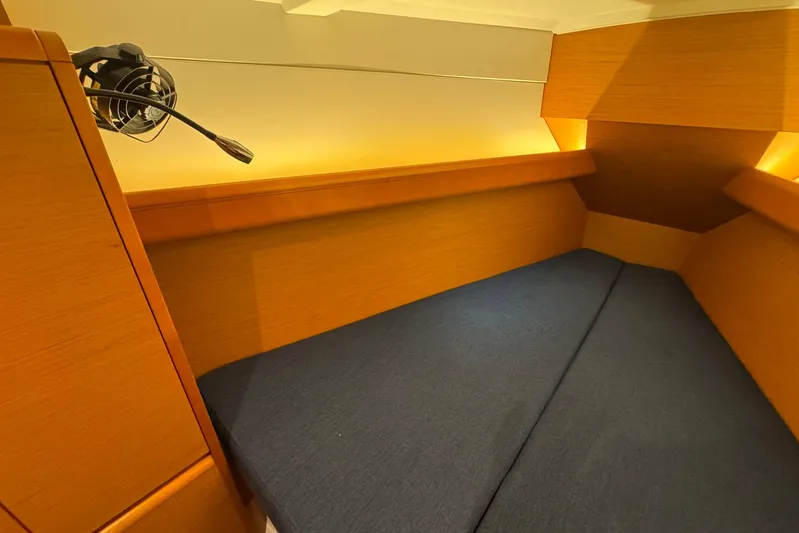 Sea Ranch II Yacht Photos Pics Cozy cabin interior of 2018 Jeanneau Sun Odyssey 389 sailboat with blue cushions.