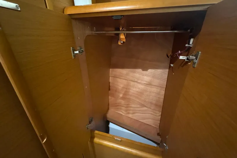 Sea Ranch II Yacht Photos Pics Open wooden cabinet inside 2018 Jeanneau Sun Odyssey 389 sailboat.