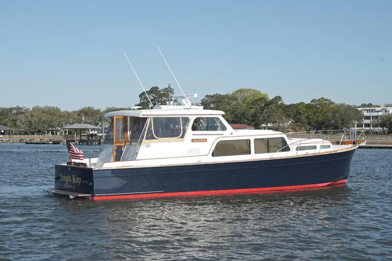 Faith Yacht Photos Pics 2003 Huckins 44 Atlantic yacht on calm water, featuring classic design and American flag.