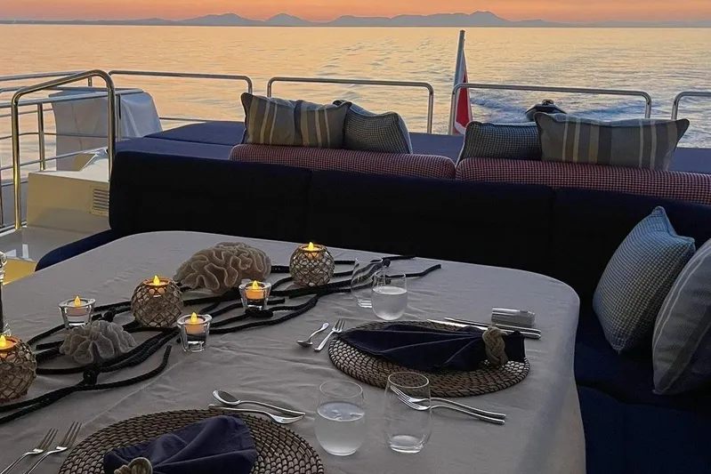 Inspiration B Yacht Photos Pics Elegant dining setup on 2006 Ferretti Custom Line 97 yacht at sunset.