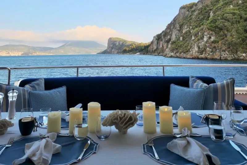 Inspiration B Yacht Photos Pics Elegant dining setup on 2006 Ferretti Custom Line 97 yacht with scenic ocean view.