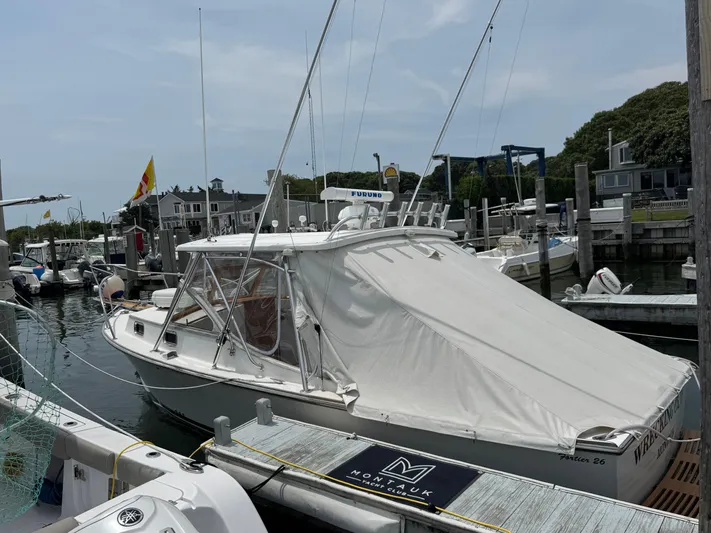 Wrecking Crew Yacht Photos Pics 2006 Fortier 26 boat docked at marina, covered with white tarp, surrounded by other boats.