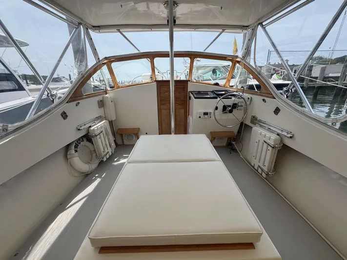 Wrecking Crew Yacht Photos Pics Interior of a 2006 Fortier 26 boat with helm and seating area.
