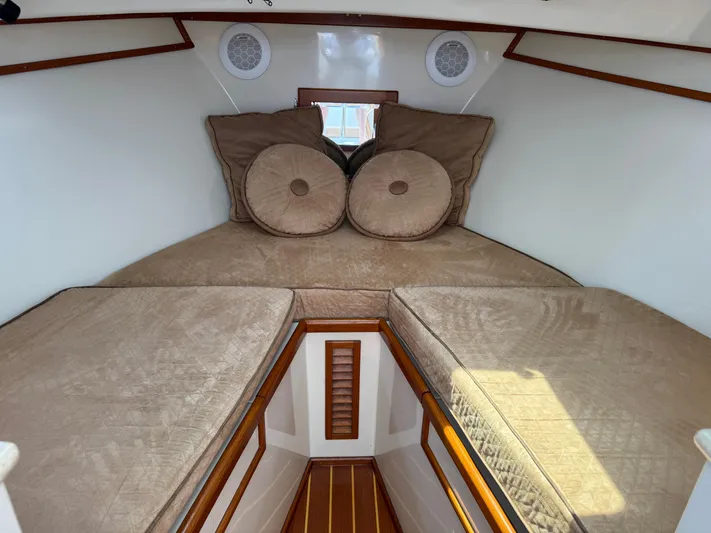 Wrecking Crew Yacht Photos Pics Cozy cabin interior of 2006 Fortier 26 boat with beige cushions and wooden accents.